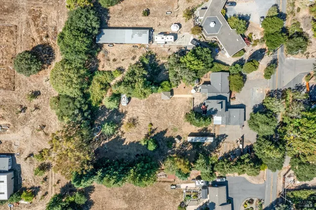 an aerial view of a house with a yard