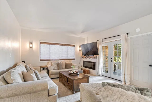 a living room with furniture flat screen tv and a fireplace
