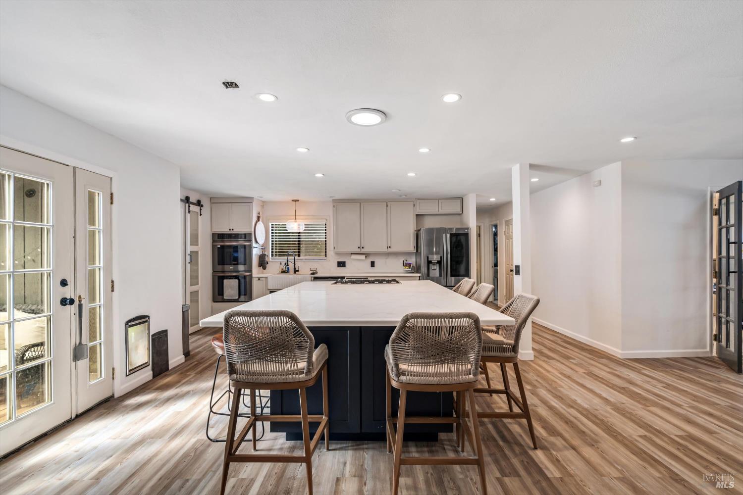 8061 Elphick Road Sebastopol, CA 95472 - Photo 7 of 40 a view of a dining room with furniture and wooden floor
