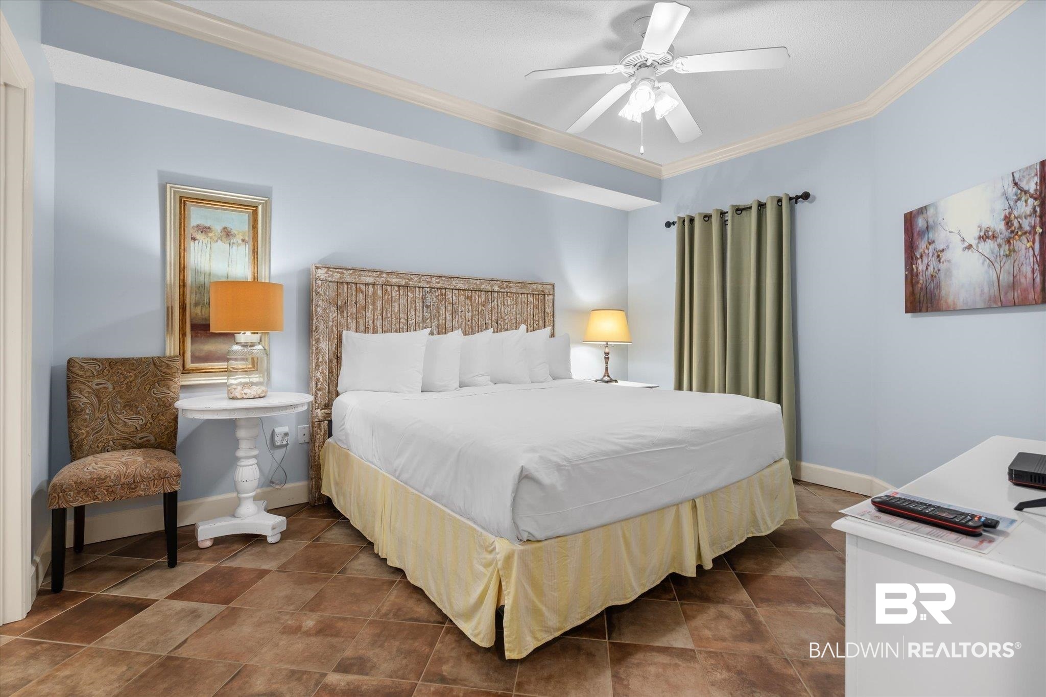 27580 Canal Road, Unit 1423 Orange Beach, AL 36561 - Photo 10 of 34 Primary bedroom featuring dark tile patterned flooring, an ensuite bathroom and ornamental molding.