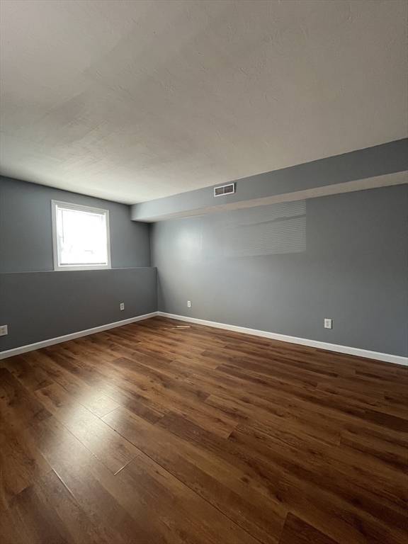 120 15th Street, Unit 4 Fall River, MA 02723 - Photo 4 of 8 a view of empty room with wooden floor and fan