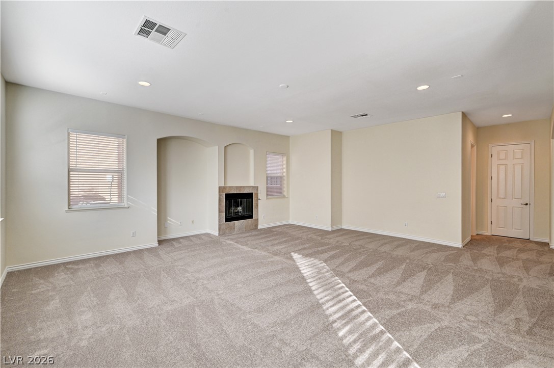 6761 Clay TABLET Street Las Vegas, NV 89149 - Photo 15 of 73 An inviting fireplace serves as the focal point in this carpeted living area.
