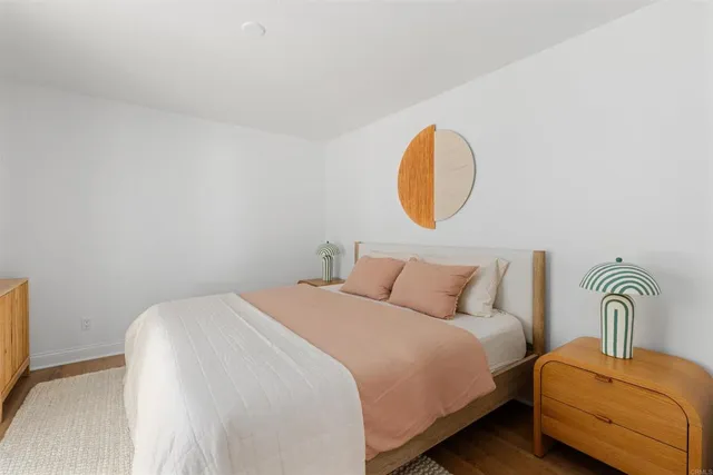 a bedroom with a bed and with a mirror