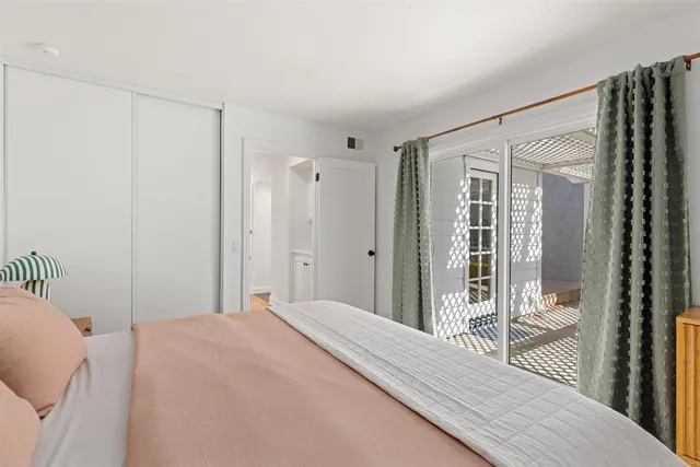 a bedroom with a bed and a window