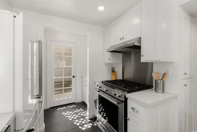 a kitchen with stainless steel appliances a stove a sink and a refrigerator