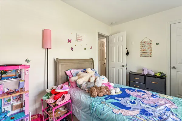 a bedroom with bed and wooden floor