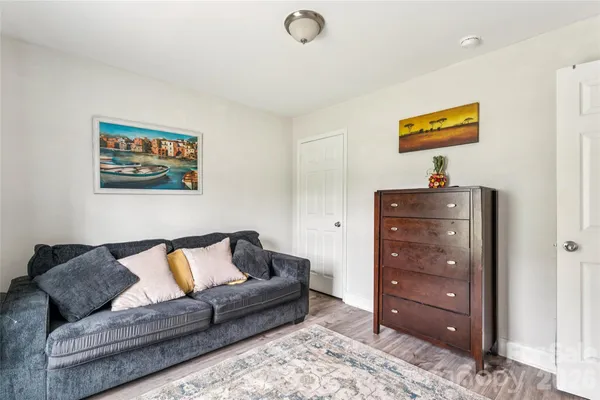 a living room with furniture and a dresser
