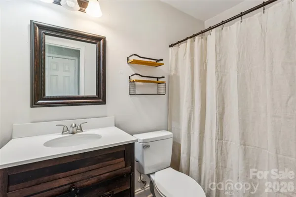 a bathroom with a sink a toilet and a mirror