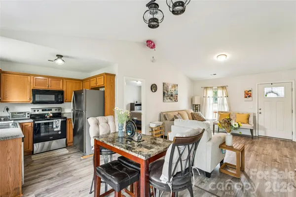 a view of a dining room with furniture window and wooden floor