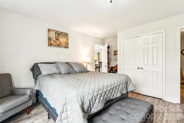 a bedroom with bed and a couch