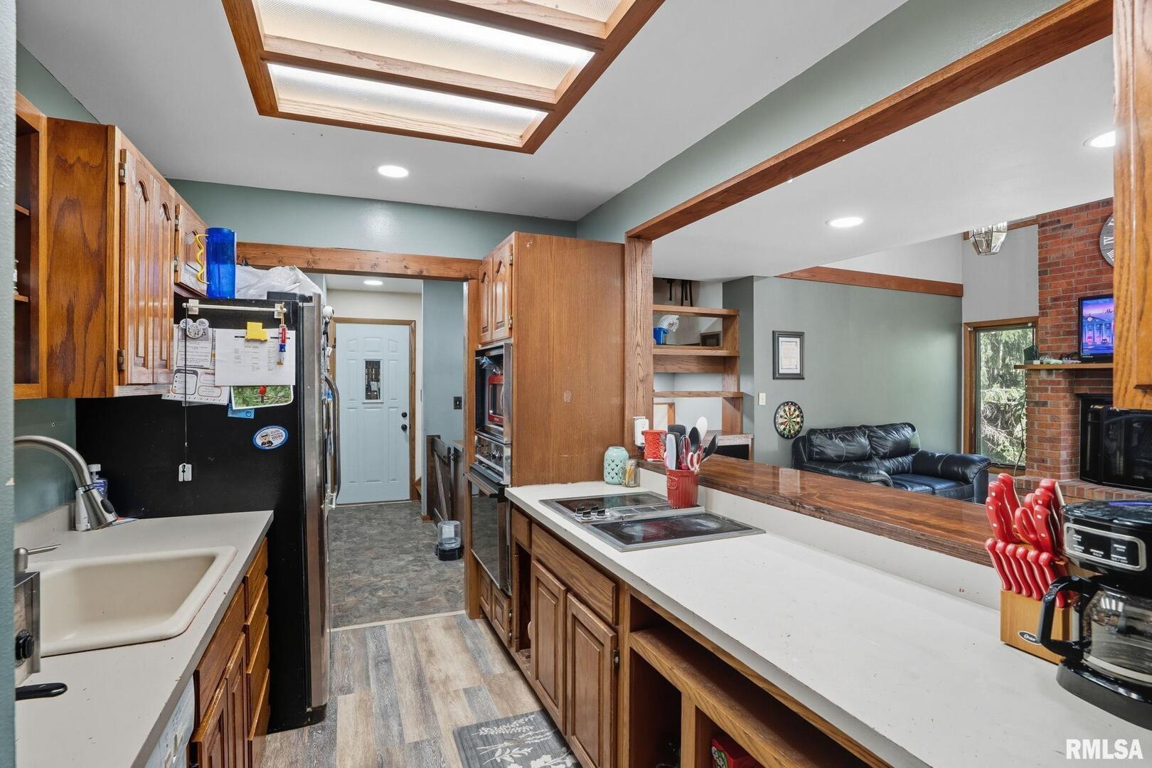 8039 Hazel Road Morrison, IL 61270 - Photo 11 of 39 a kitchen with stainless steel appliances kitchen island granite countertop a sink stove and cabinets