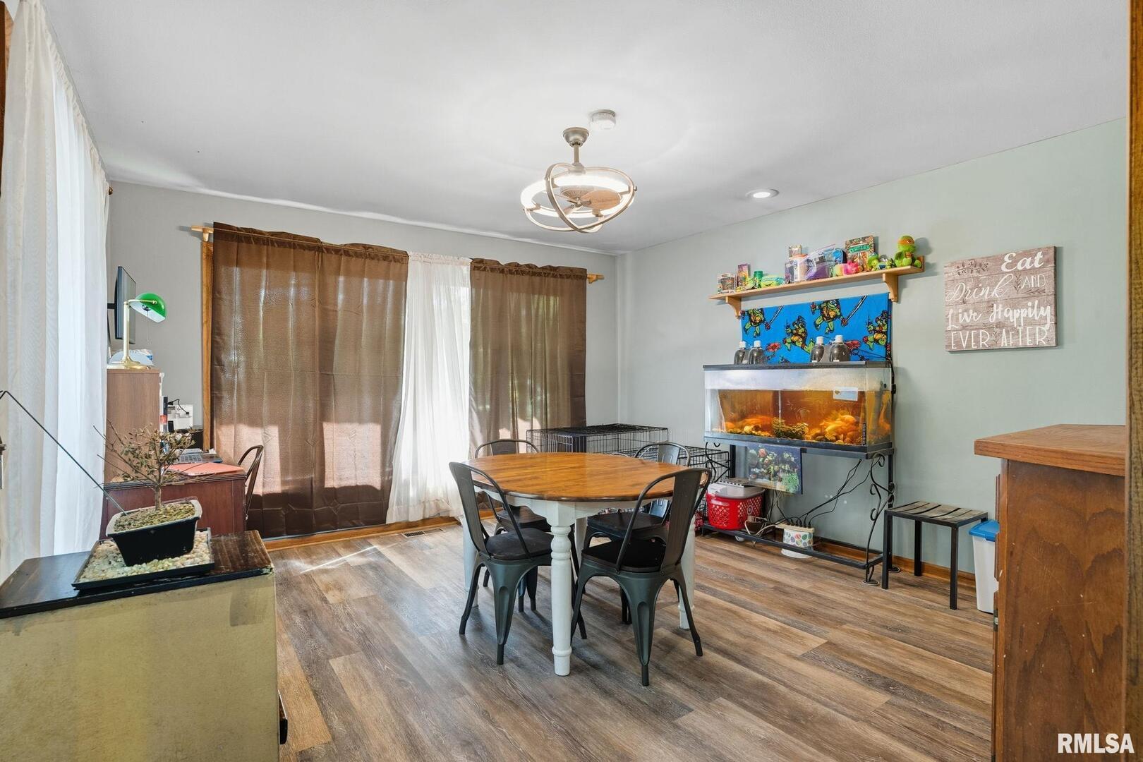 8039 Hazel Road Morrison, IL 61270 - Photo 12 of 39 a dining room with furniture a rug and wooden floor