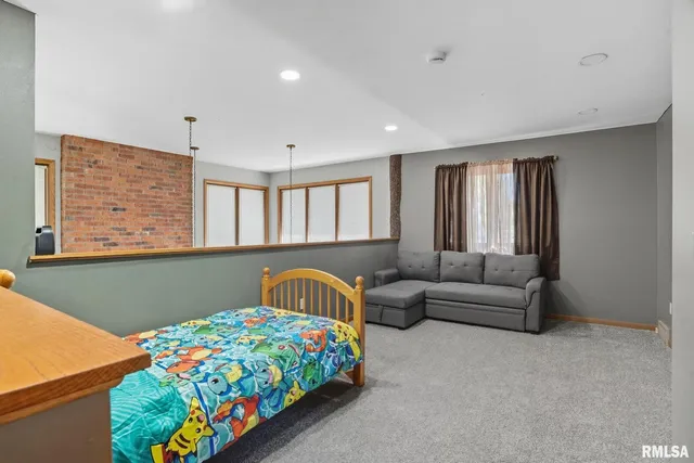 a bedroom with a bed and a couch