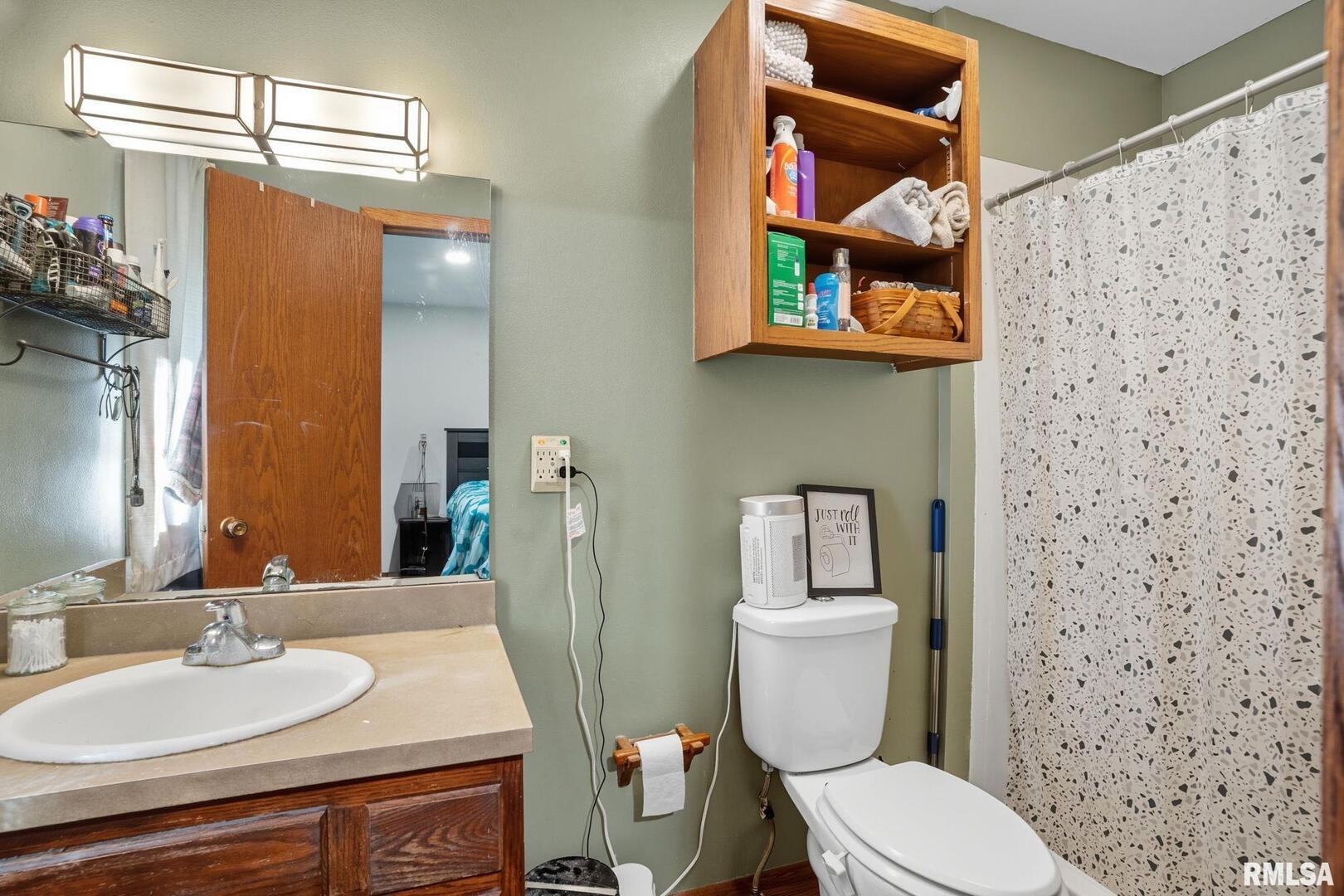 8039 Hazel Road Morrison, IL 61270 - Photo 22 of 39 a bathroom with a sink and a mirror