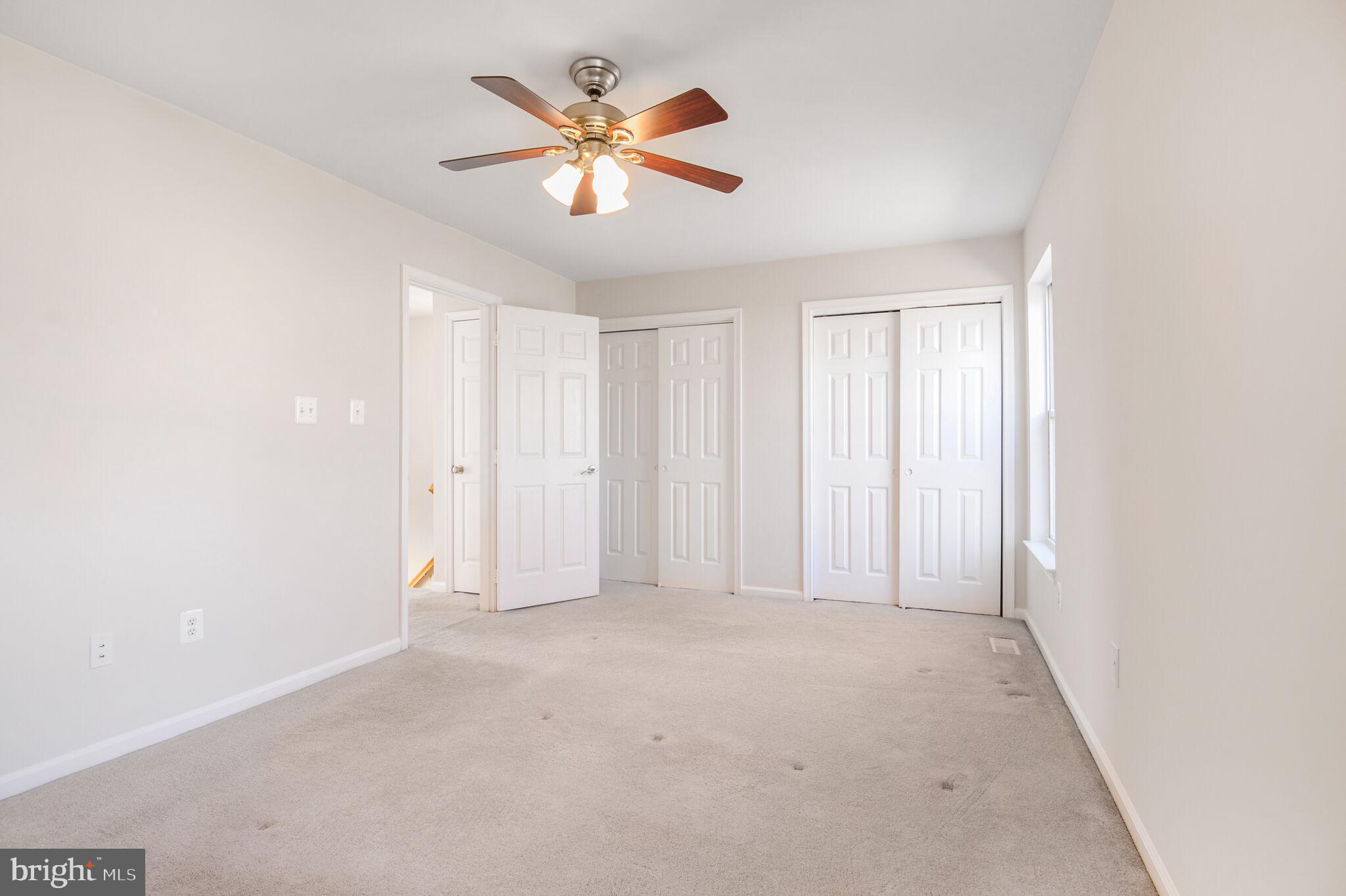 14812 Edman Circle Centreville, VA 20121 - Photo 11 of 24 an empty room with chandelier fan and windows