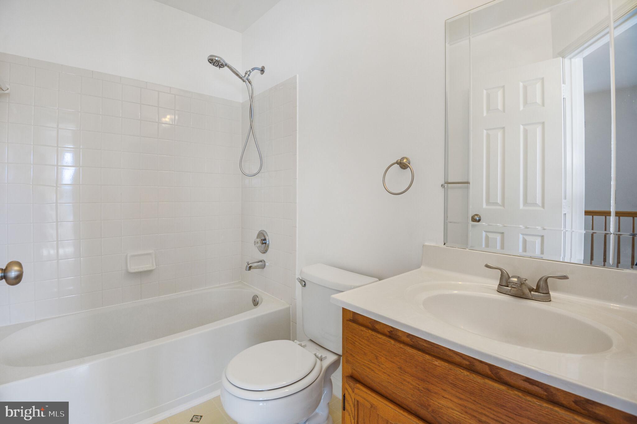 14812 Edman Circle Centreville, VA 20121 - Photo 16 of 24 a bathroom with a granite countertop sink a toilet and shower
