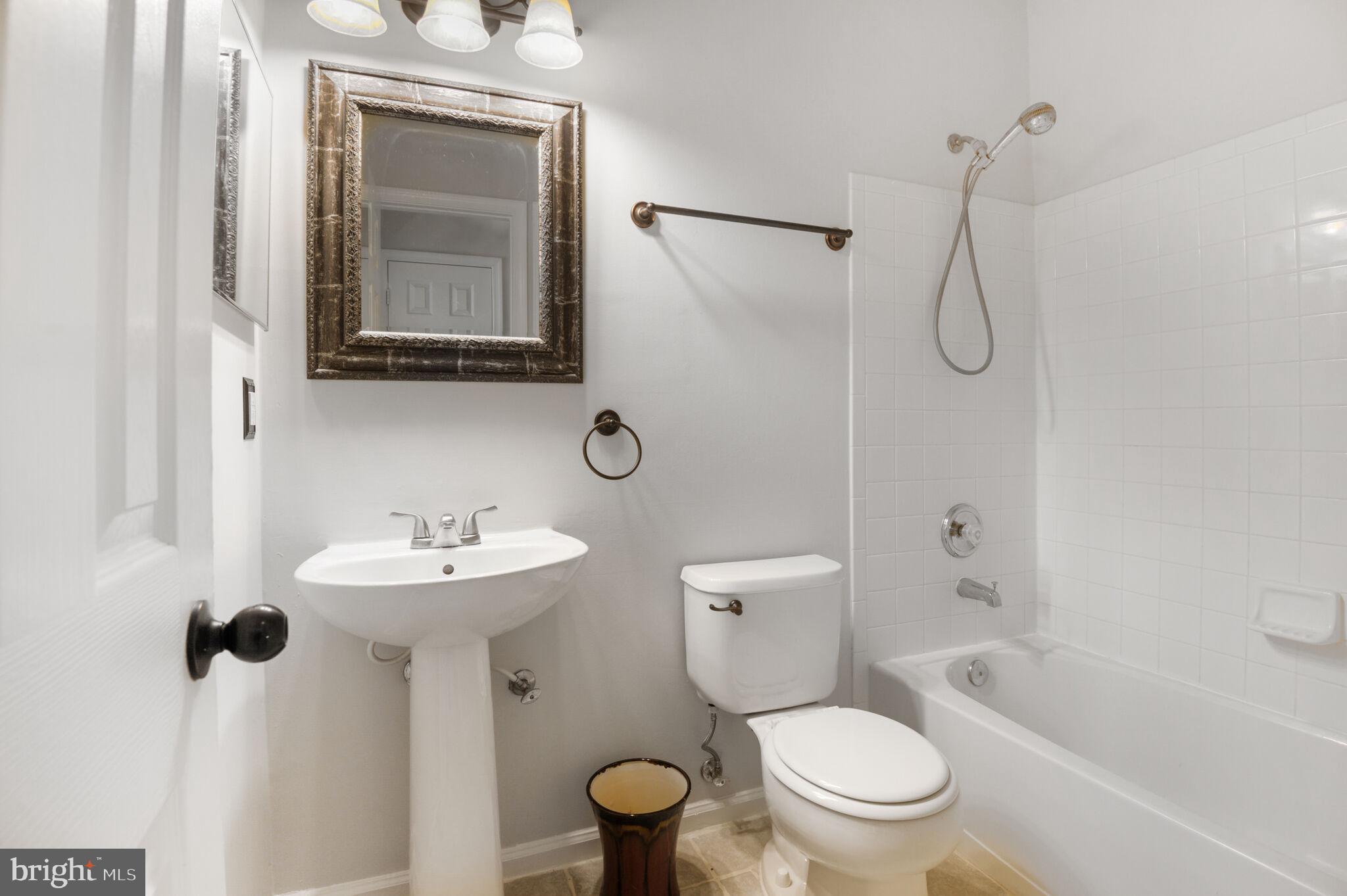 14812 Edman Circle Centreville, VA 20121 - Photo 19 of 24 a bathroom with a toilet sink shower and mirror