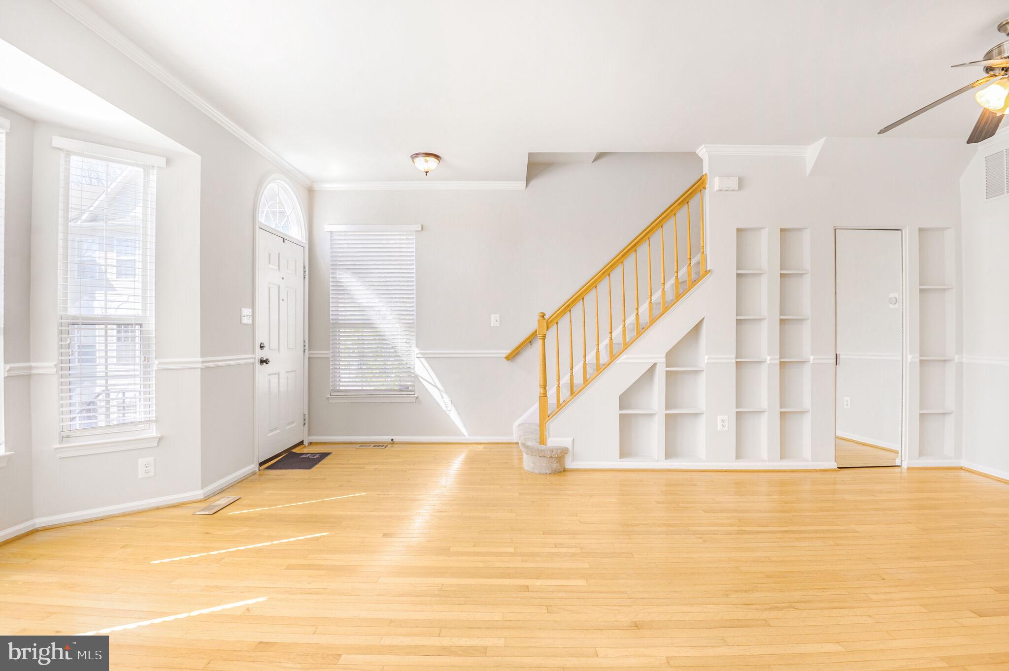 14812 Edman Circle Centreville, VA 20121 - Photo 2 of 24 a view of an empty room with wooden floor and a window