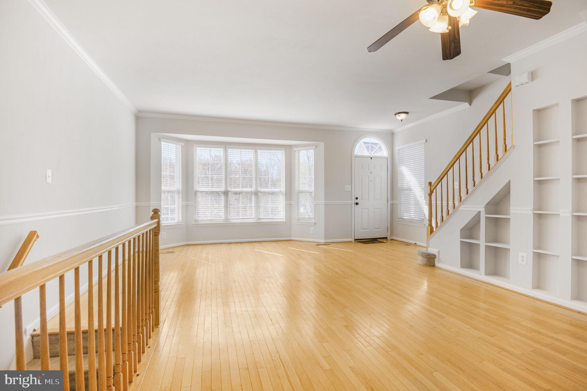14812 Edman Circle Centreville, VA 20121 - Photo 3 of 24 a view of an empty room with wooden floor and a window
