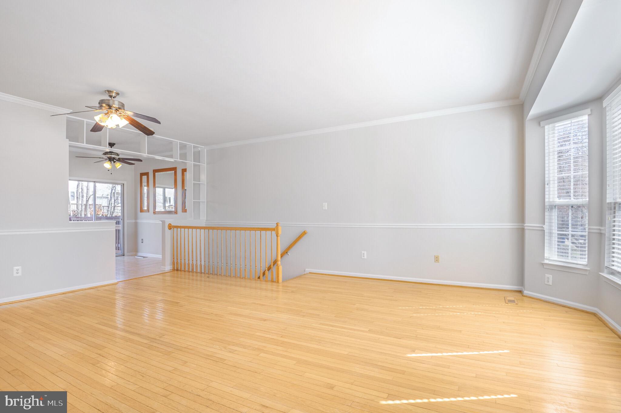 14812 Edman Circle Centreville, VA 20121 - Photo 4 of 24 a view of empty room with wooden floor and fan