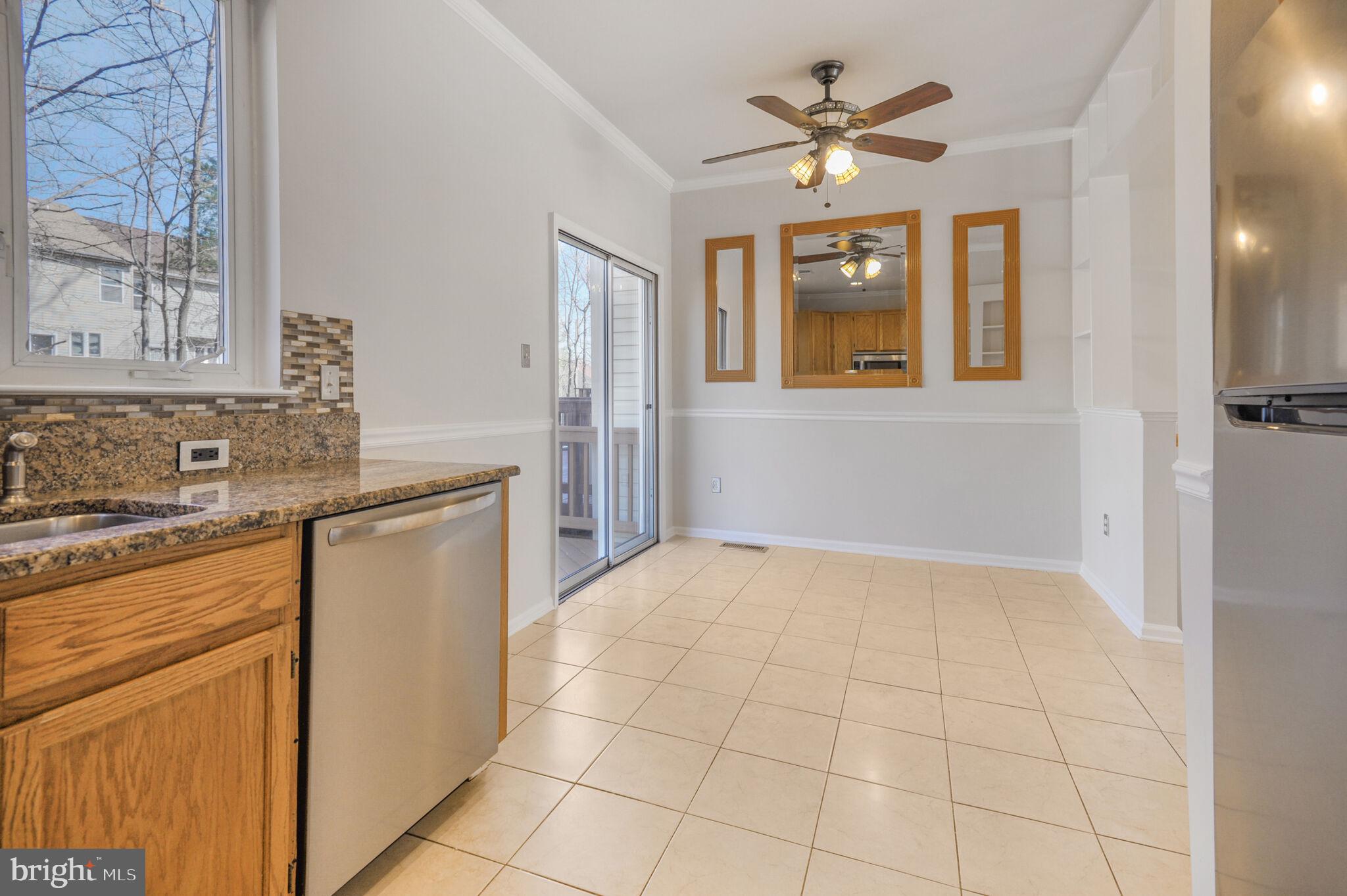 14812 Edman Circle Centreville, VA 20121 - Photo 8 of 24 a kitchen with granite countertop a stove a sink and a window