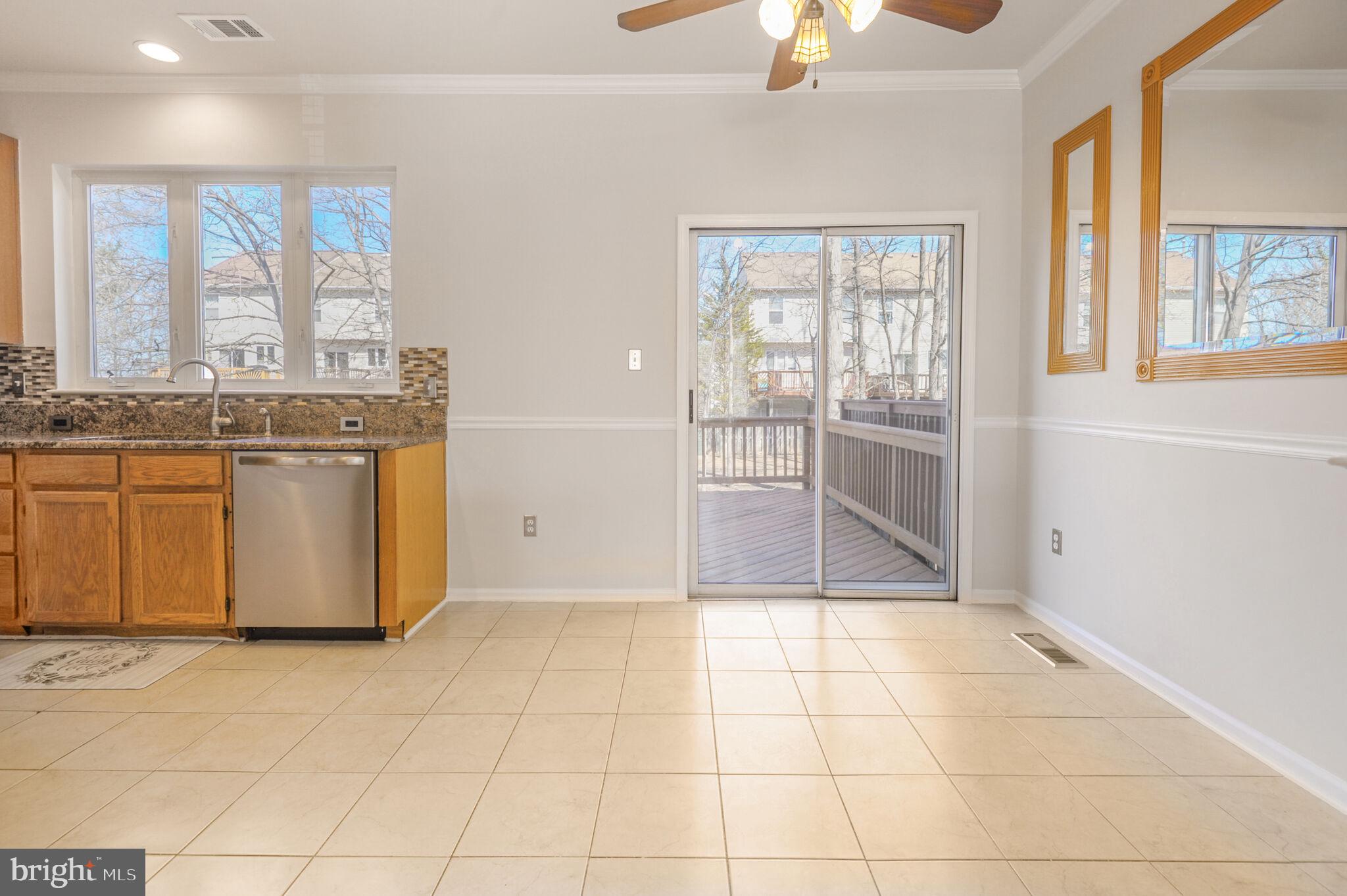 14812 Edman Circle Centreville, VA 20121 - Photo 9 of 24 a view of a kitchen with granite countertop a sink and a refrigerator