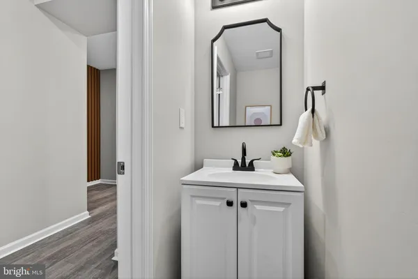 a bathroom with a sink vanity and a mirror