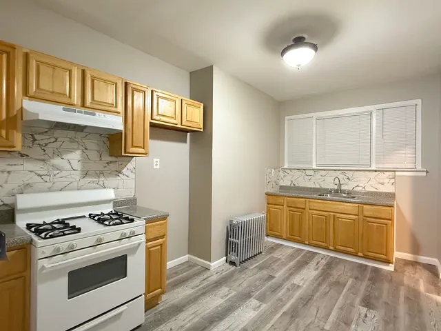 a kitchen with stainless steel appliances granite countertop a stove and a sink