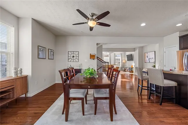 a dining room with furniture a rug and wooden floor