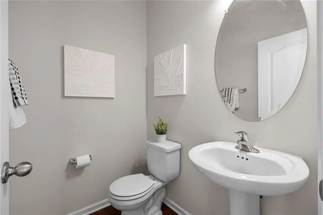 a bathroom with a sink a mirror and a toilet