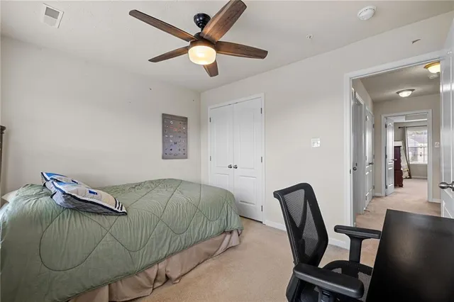 a bedroom with a bed and a chair