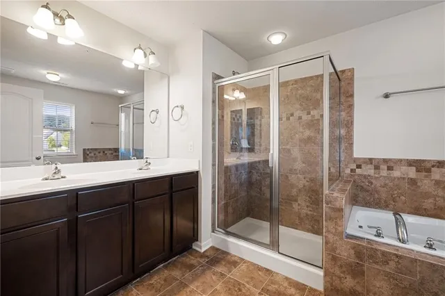 a bathroom with a shower sink and mirror