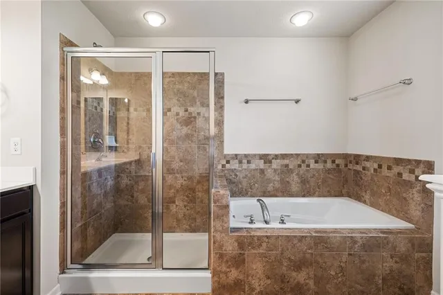 a bathroom with a bathtub and a shower
