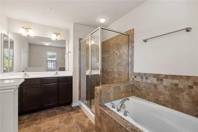 a bathroom with a bathtub sink and mirror
