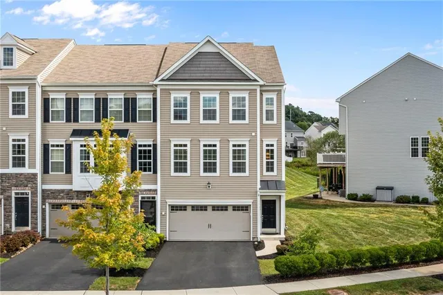 an aerial view of multiple houses with a yard