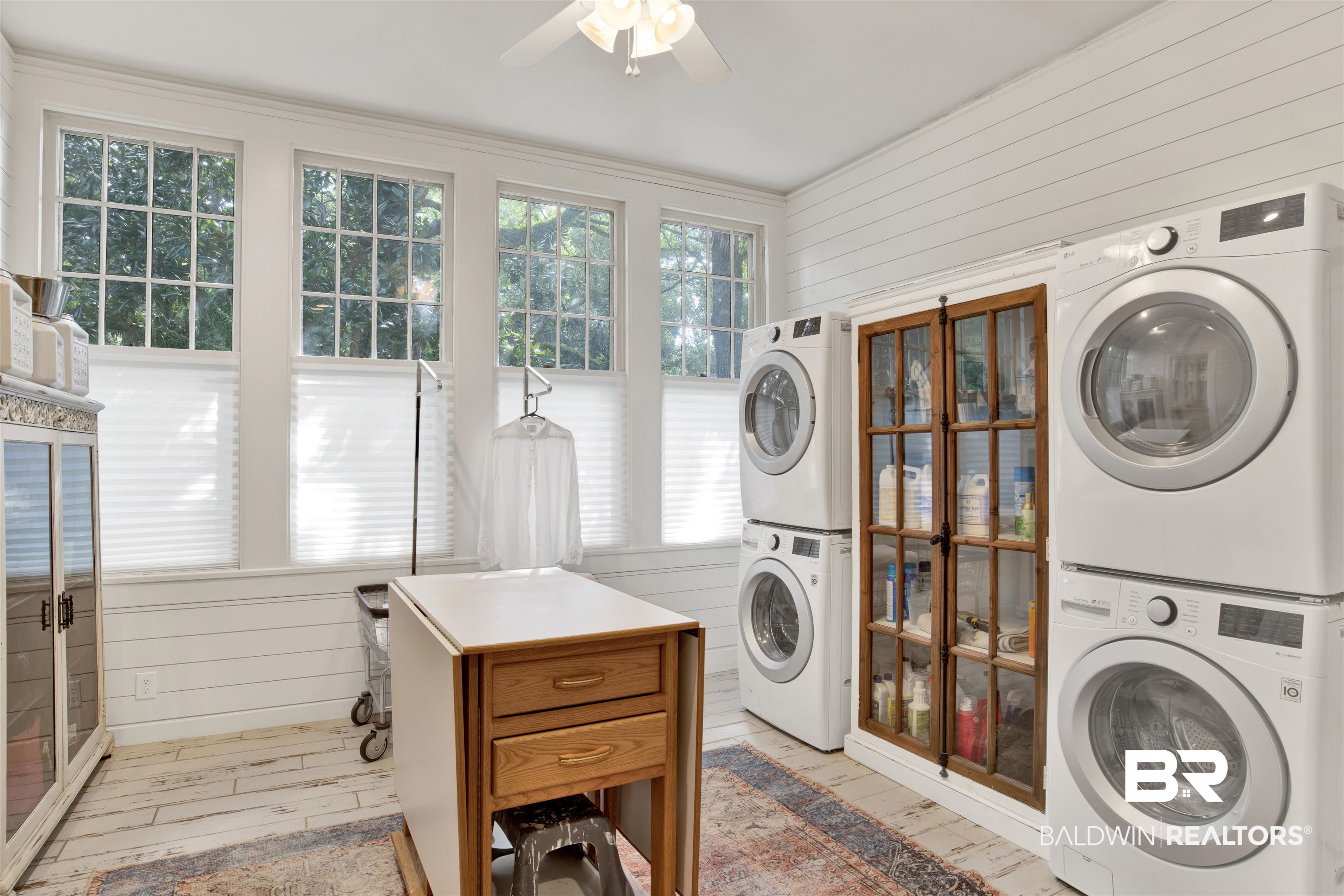 1654 Government Street Mobile, AL 36604 - Photo 32 of 45 Clothes washing area with light hardwood / wood-style flooring, ceiling fan, and stacked washer / drying machine