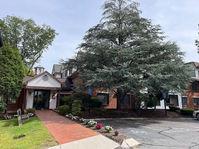a front view of a house with a garden and sitting area