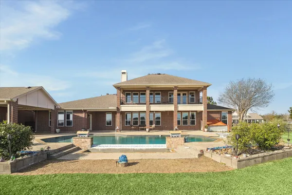 a swimming pool with outdoor seating and yard