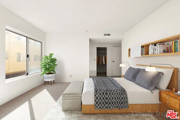 a bedroom with a large bed and a couch