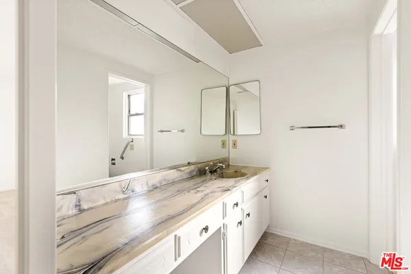 a bathroom with a double vanity sink and a mirror