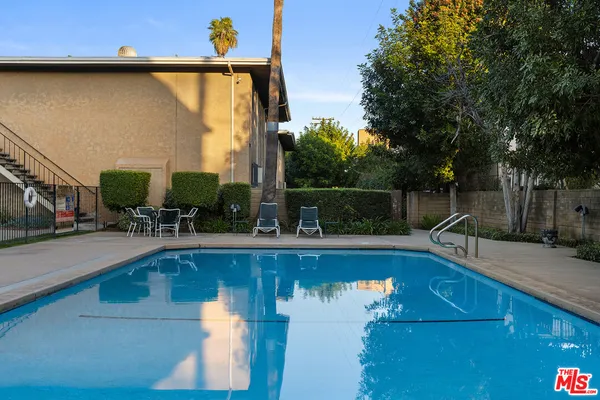 a view of swimming pool with chairs