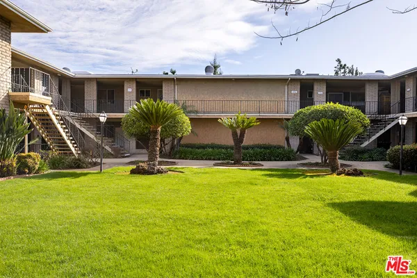 a swimming pool with yard in front of it