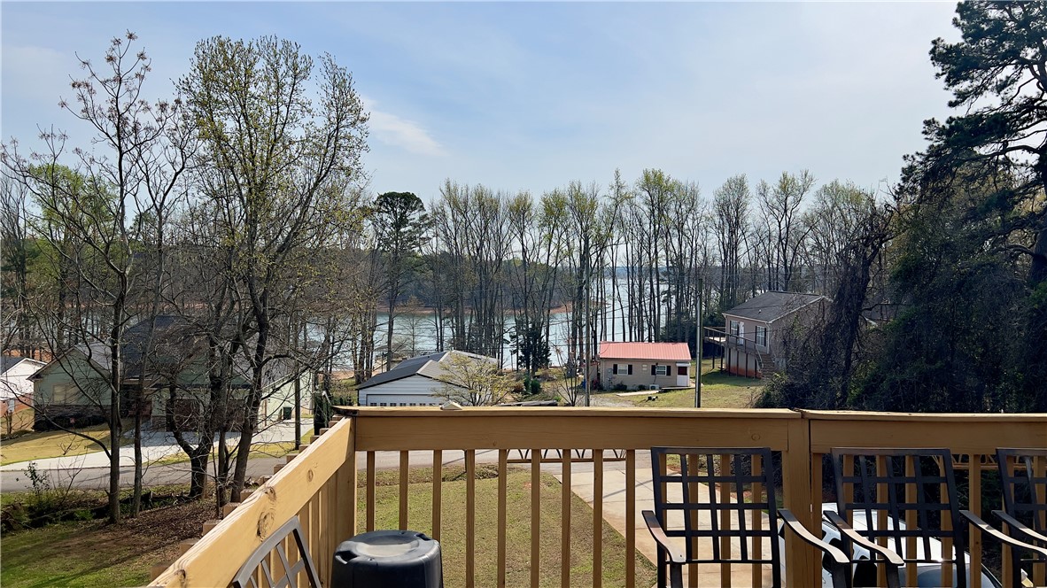 160 Hudgins Lake Road Townville, SC 29689 - Photo 39 of 41 Uninterrupted lake vistas unfold from this elevated porch, offering a serene backdrop to daily living.