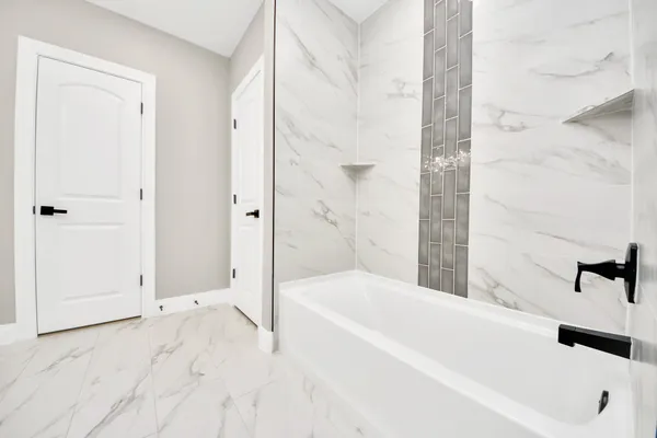 a bathroom with a bathtub and a shower