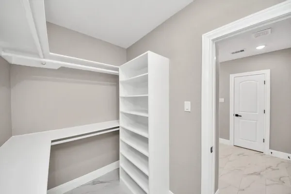 a view of an empty walk in closet