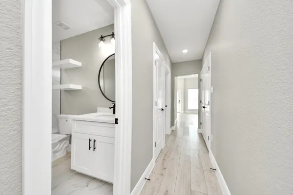 a view of a bathroom from a hallway