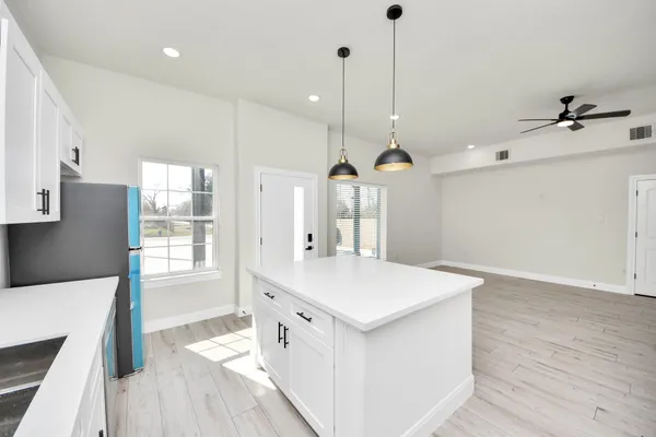 a view of a kitchen with wooden floor