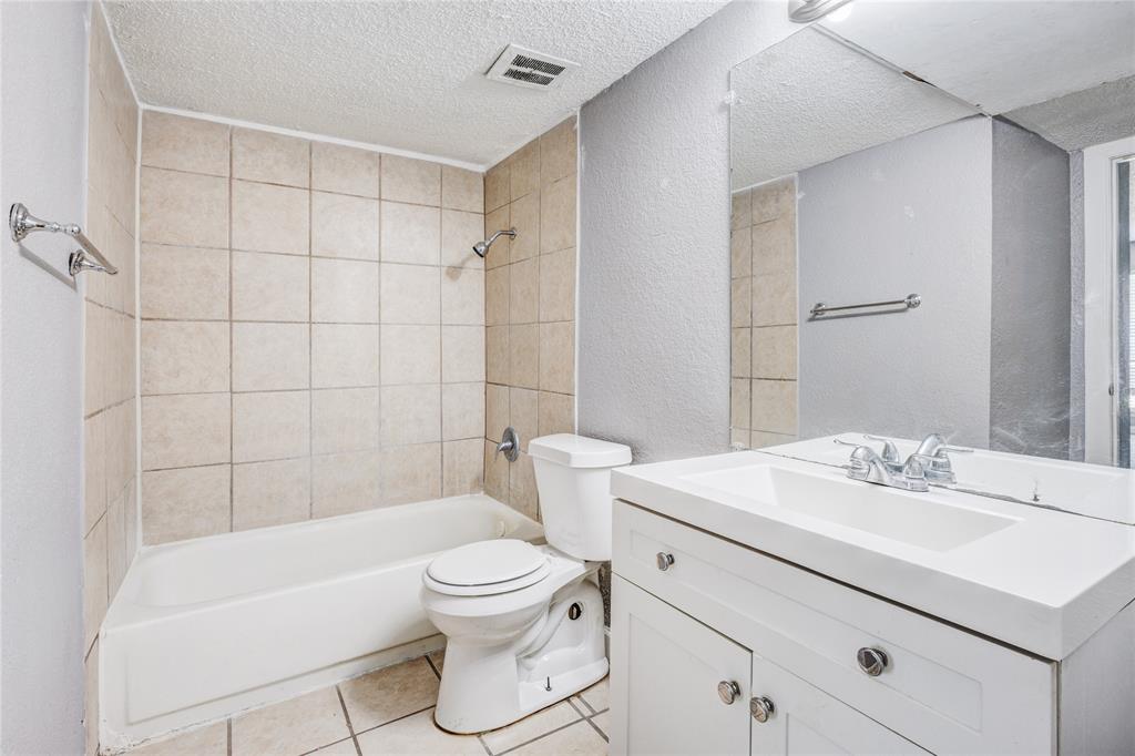 5063 Ridglea Lane, Unit 1002 Fort Worth, TX 76116 - Photo 7 of 11 a bathroom with a sink toilet vanity and shower