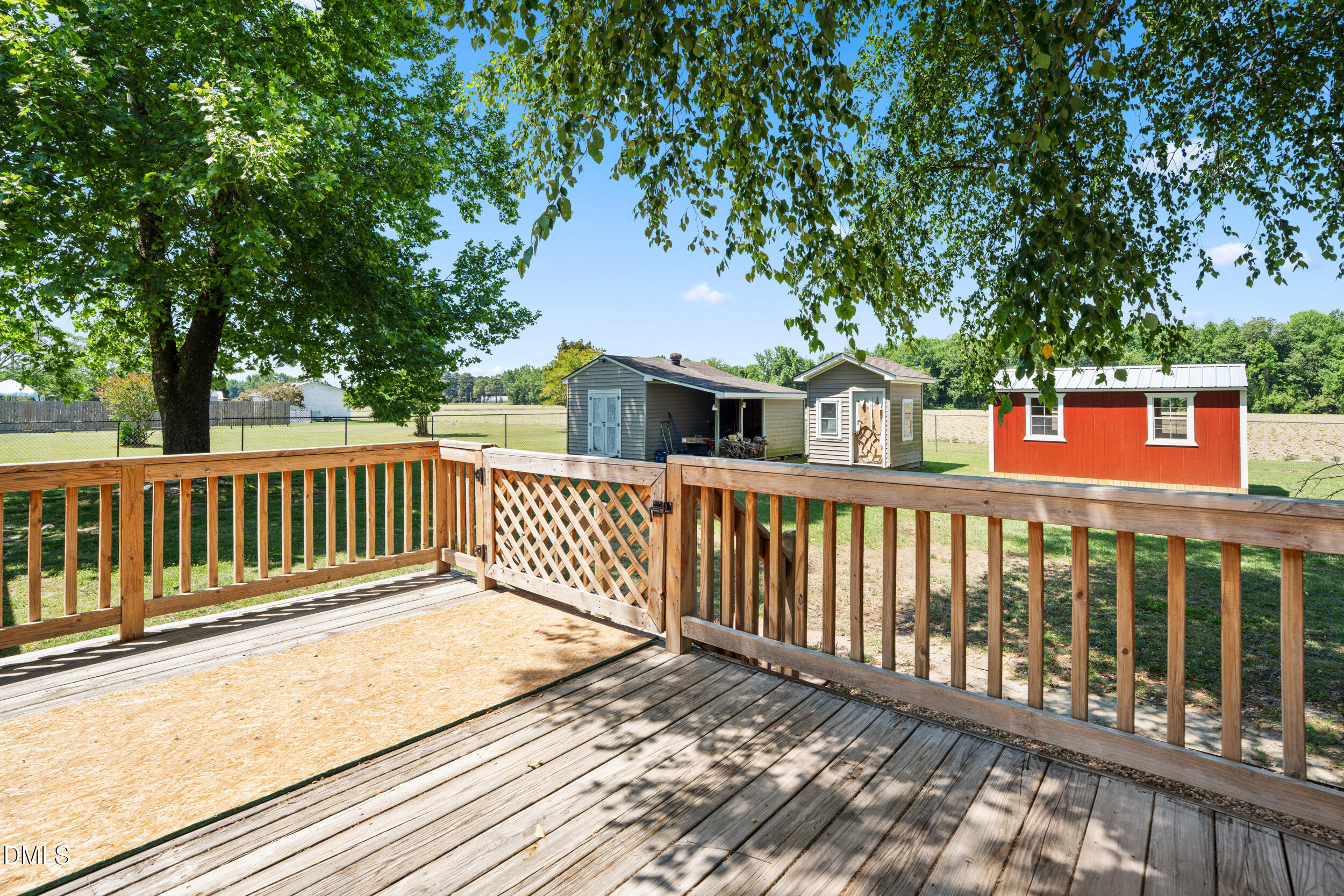 311 Bridgers Road Kenly, NC 27542 - Photo 29 of 46 a balcony of a house with wooden floor and fence