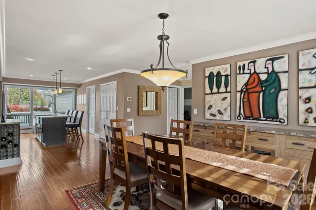 a kitchen with a table chairs stove and cabinets